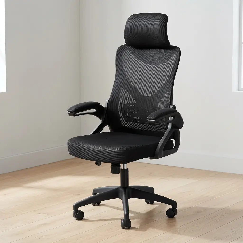 Black and grey leather-look office chair with high back, flip-open footrest extended, and adjustable headrest in a professional office
