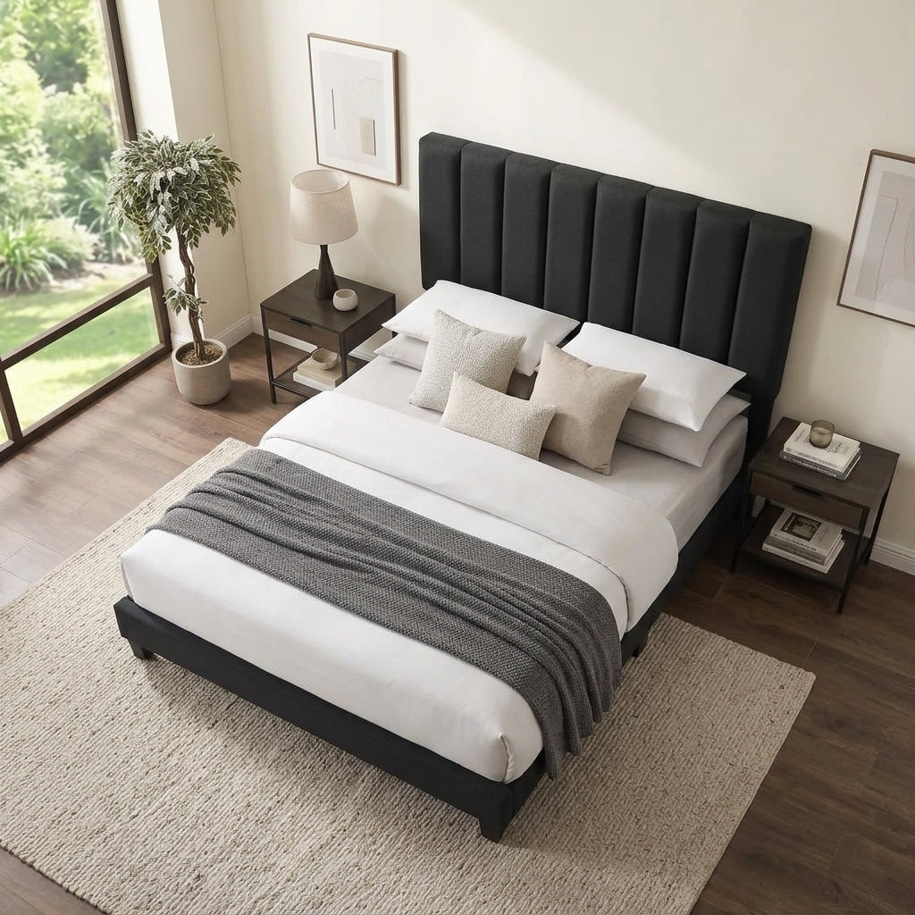 Black velvet upholstered bed with tall padded adjustable headboard in a contemporary bedroom