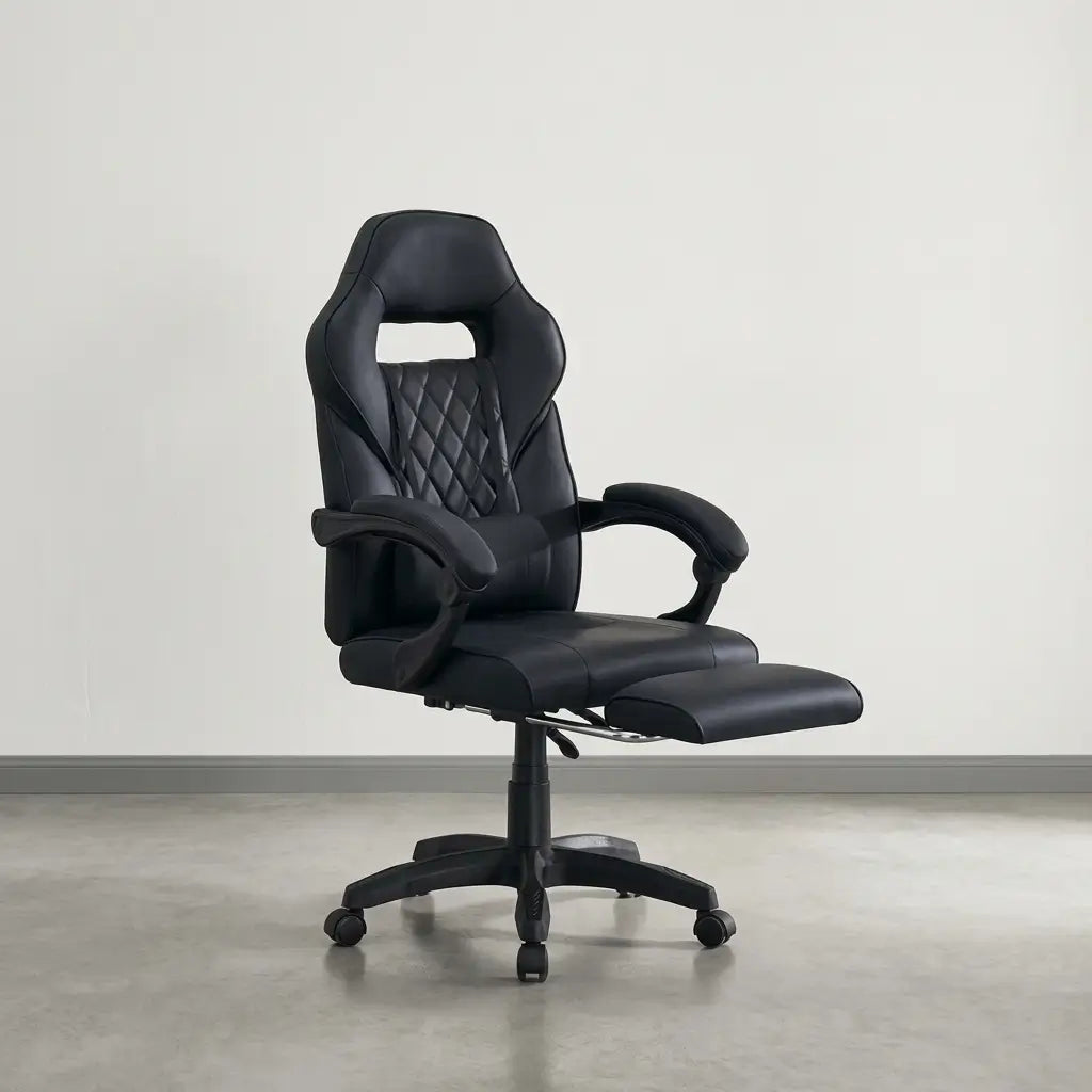 Black high-back racing style chair reclined with pull-out footrest extended, padded armrests, and diamond-stitched backrest in a gaming setup
