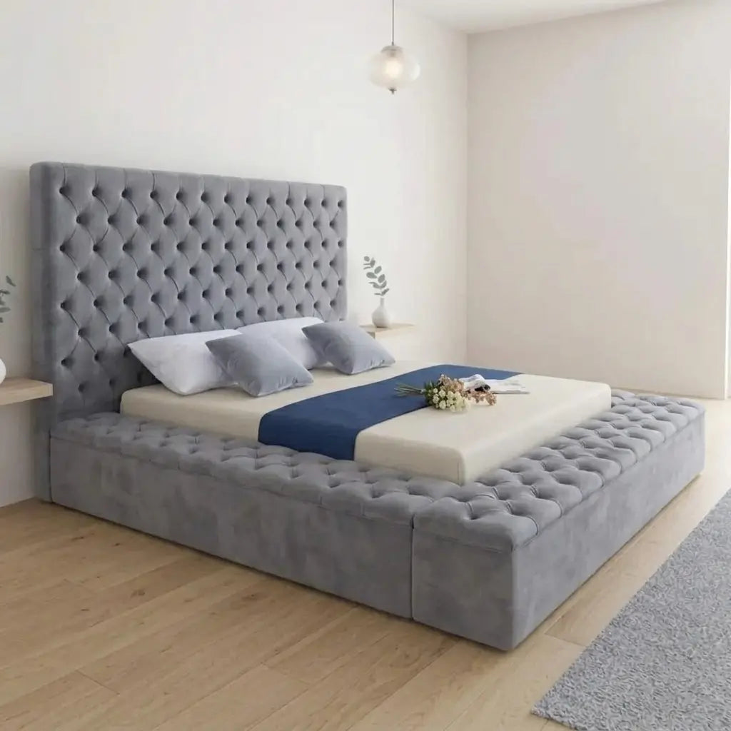Grey velvet platform bed with padded diamond button-tufted headboard and tufted storage side rails in a modern bedroom