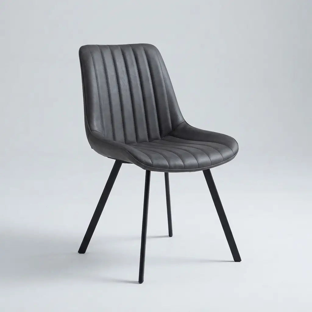 7-Piece Marble-Look Sintered Stone Dining Set close-up showing a dark grey ribbed faux velvet chair seat with slim black metal legs