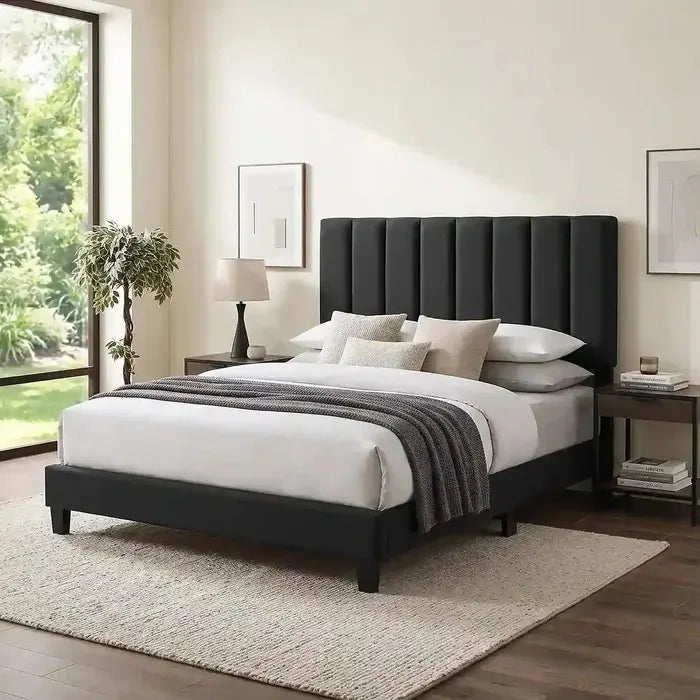 T-2118 Black Velvet Bed Frame with vertical channel tufting on the headboard, set in a modern bedroom with a large window and nightstands.