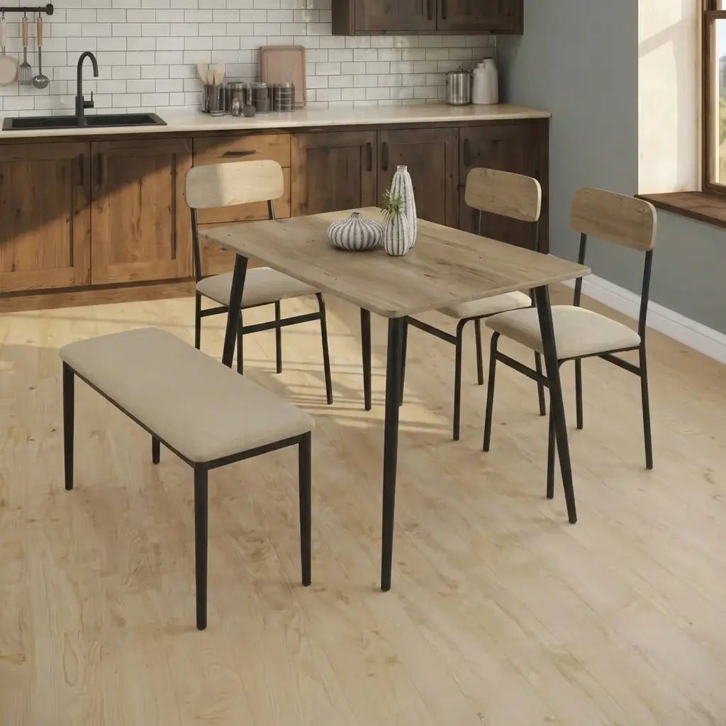 Rectangular rustic oak-look dining table with black metal legs and four cushioned chairs in a small kitchen dining area