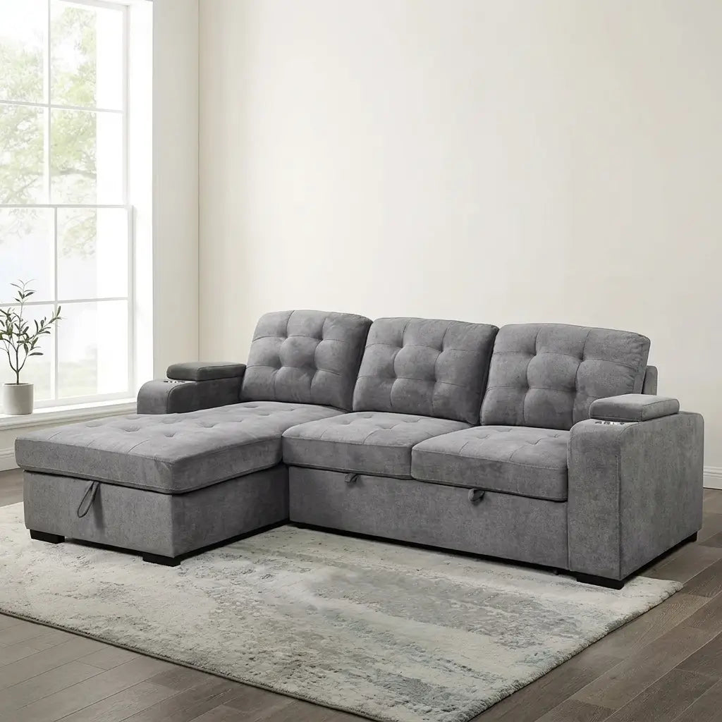 Contemporary grey chaise sectional that converts into a bed, shown with a floating storage ottoman in a multifunctional living space