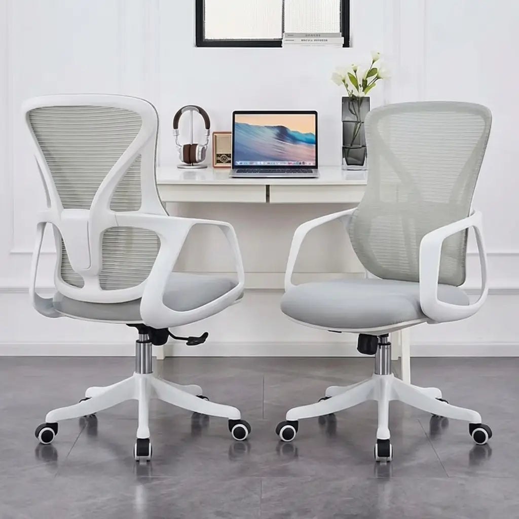 Ergonomic office chair with breathable mesh back, contoured back support, and fixed loop armrests at a desk