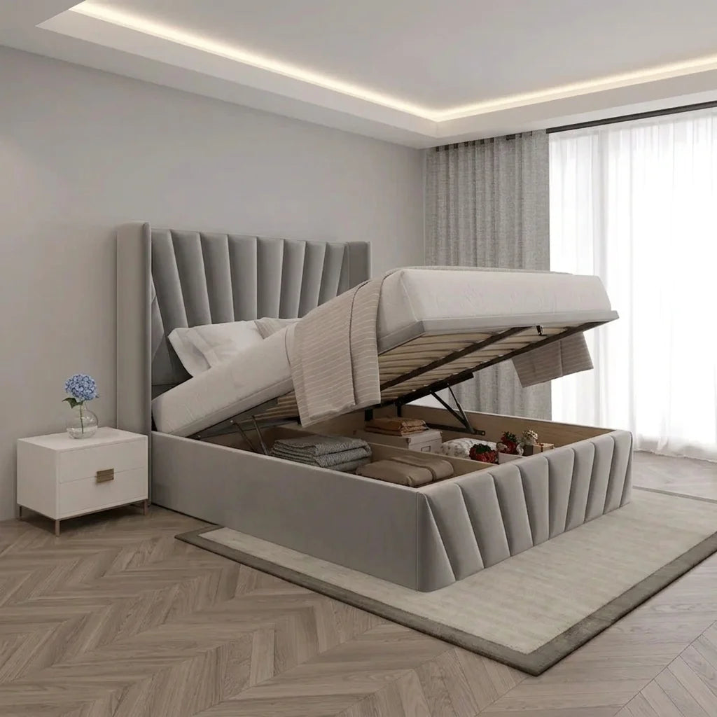 Grey upholstered bed frame with padded wingback headboard and matching footboard in a modern bedroom