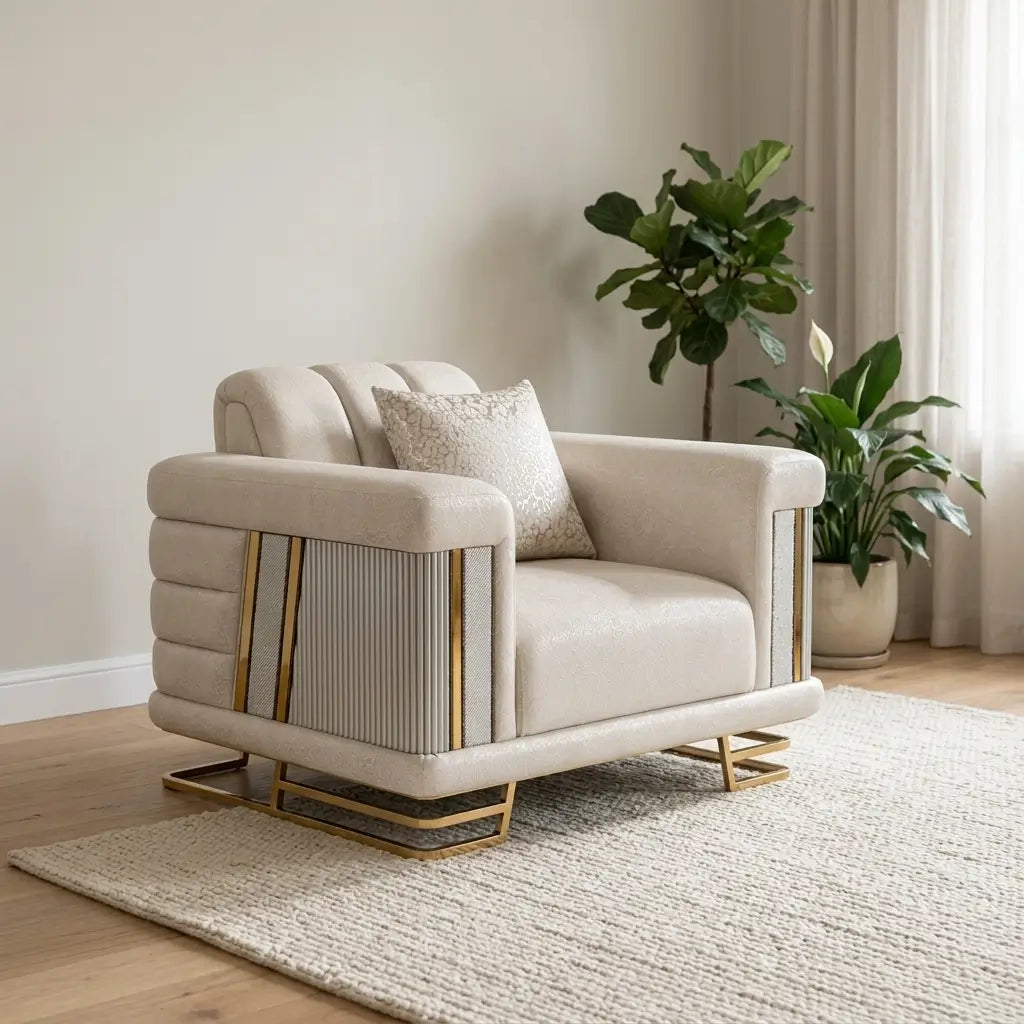 A modern beige armchair with gold metal accents and a textured throw pillow, styled in a minimalist living room setting