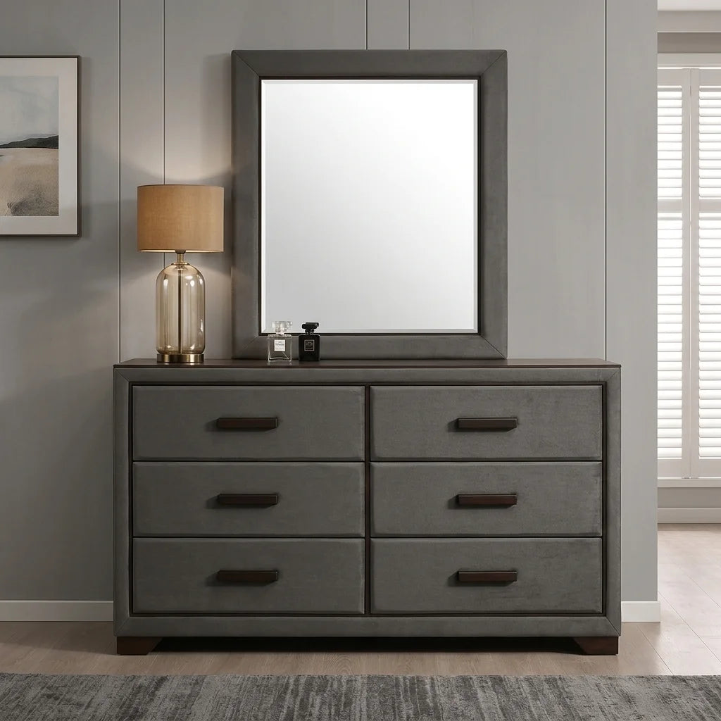 Grey upholstered 6-drawer double dresser with dark top, wood handles, and matching framed wall mirror