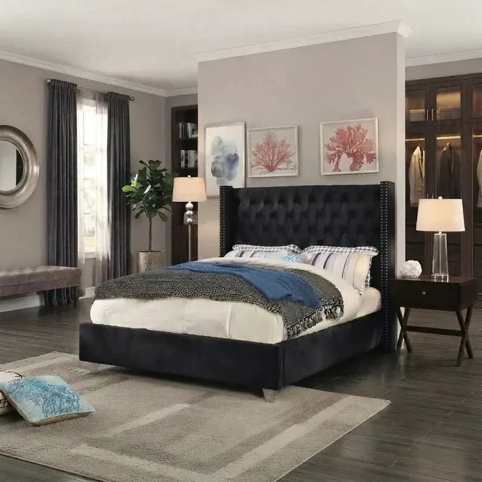 Black diamond-tufted velvet wingback bed with silver nailhead trim